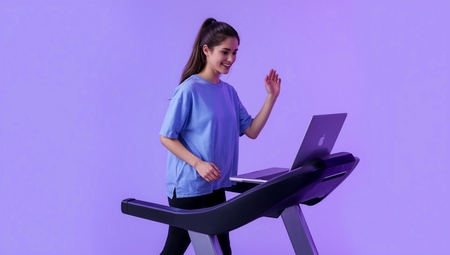 A woman is using a tread treadmill