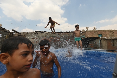 Children swimming in a pool in a traditional neighborhood in Egypt.