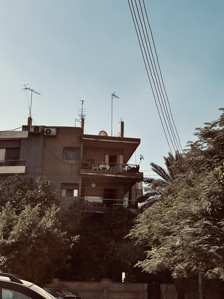 A street in a neighborhood in Cairo shows a building with balconies