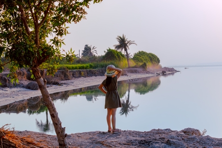 A little girl stands on the shore of Lake Qarun, Egypt.
