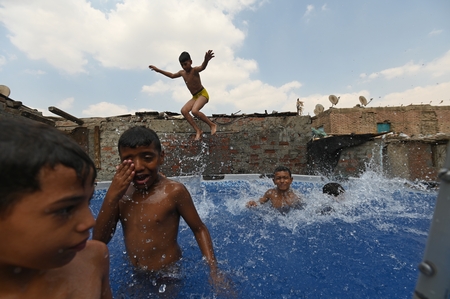 Children swimming in a pool in a traditional neighborhood in Egypt.