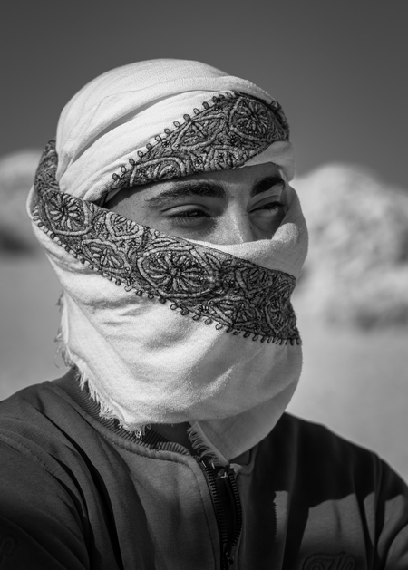 A monochrome portrait of a young Egyptian Bedouin.