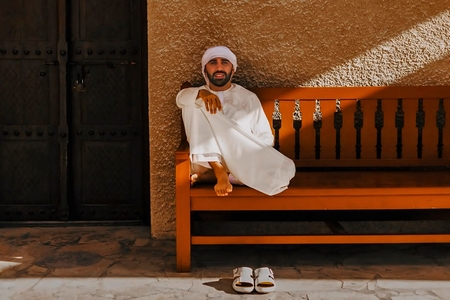 a man in a traditional khaleeji outfit (kandura)