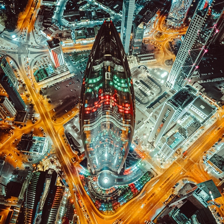 Kuwait Tower skyline glowing at night.