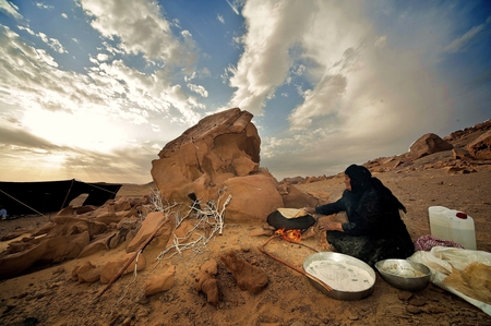 A woman making bread in the traditional way in the desert