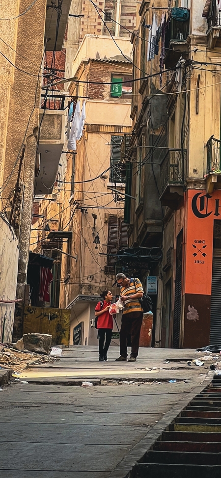 a man walks through the streets of the old city