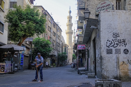 A man sweeping the street in Cairo, Egypt